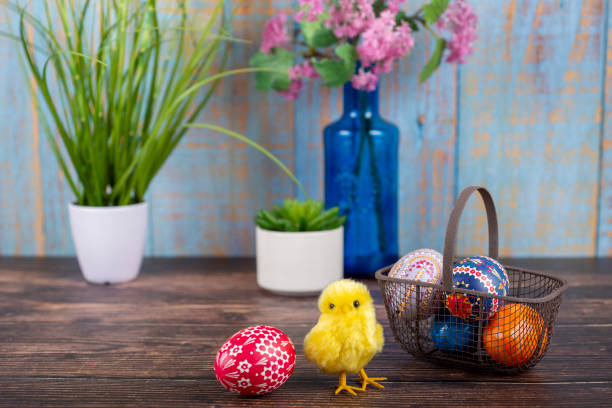 istock Easter. Basket with painted Easter eggs, magnolia and chicken 1458497614