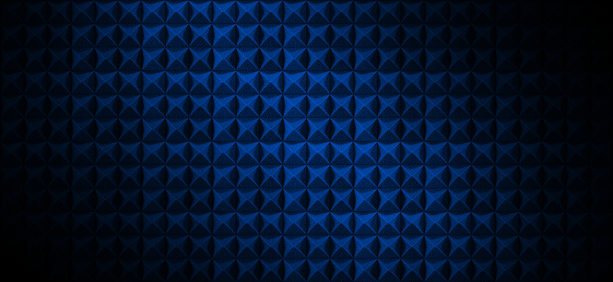 Dark acoustic foam wall with blue light. Recording studio room background with sound proofing texture. Radio broadcast or podcast background with copy space for website banner design