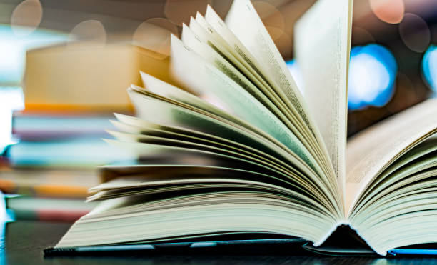 istock An open hardcover book on a table in a public library 1458500225