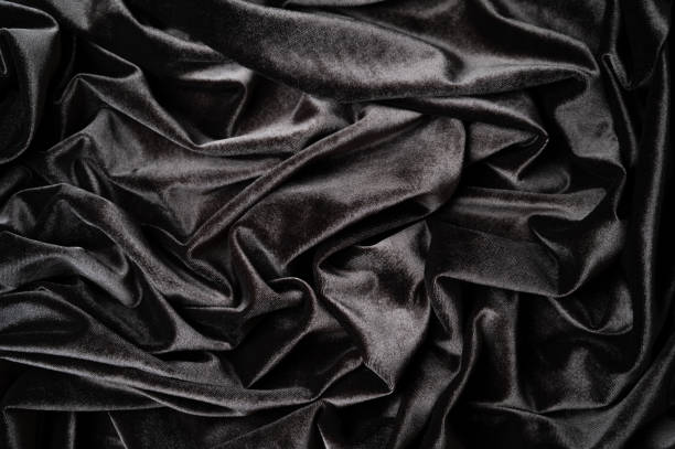 istock Rumpled dark velvet background, dark gray or black fabric texture background 1458500325