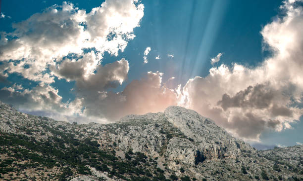 landscape with clouds and sunlight over the mountains