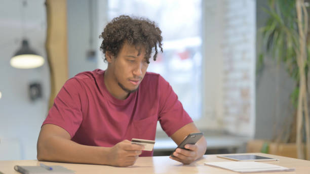 istock African Man making Successful Online Payment on Smartphone 1458501539