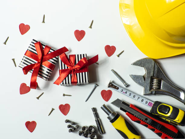 istock Construction tools and gifts on white background with small red hearts 1458502271