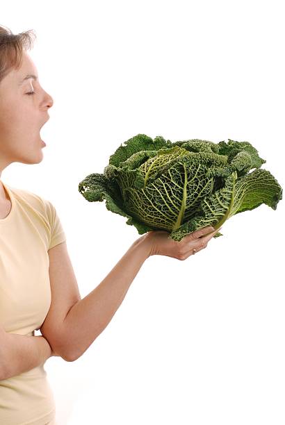 istock Woman wanting to eat savoy cabbage - isolated 145850316