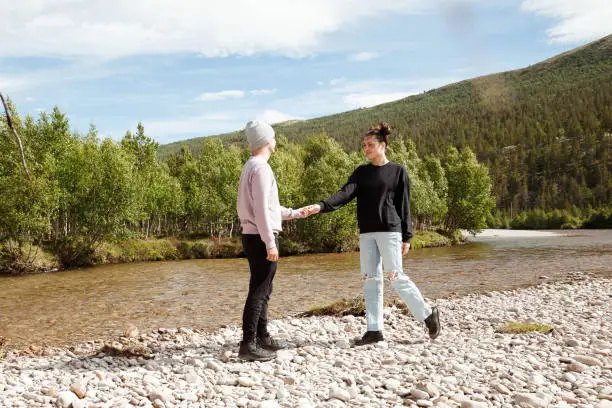 A young couple enjoyes a moment together at a water stream in Norway