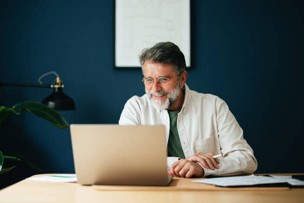 Happy Senior Businessman Working At Home