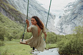 Woman swinging into nature