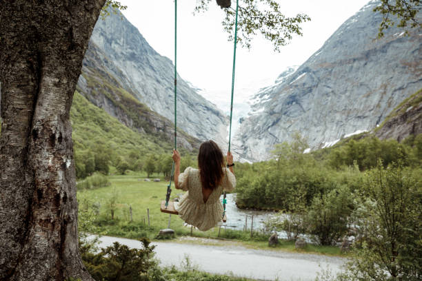 istock Woman swinging into nature 1458504285