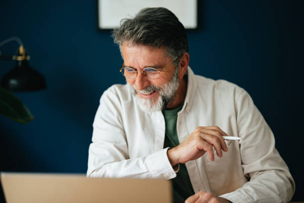 istock Smiling Mature Businessman Working At Home 1458504299