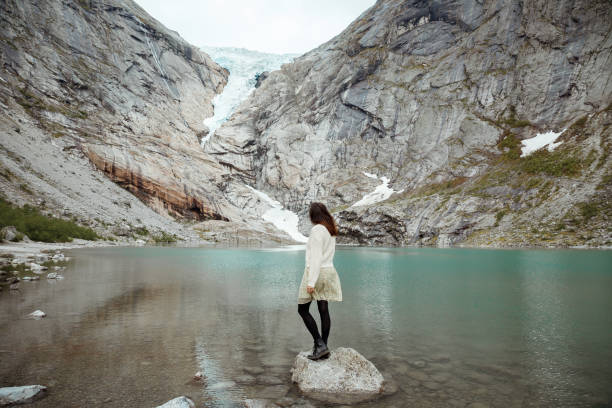 istock A woman standing in front of Briksdal glacier, Norway 1458504332