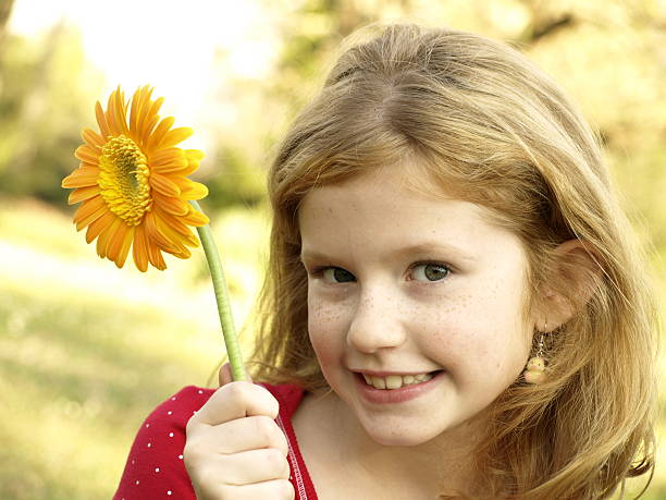 istock Girl and the Daisy 145850525