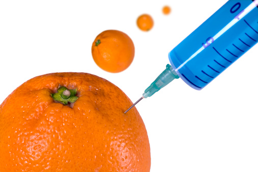 an image pointing out the concept of food adulteration, symbolized by an injection of blue fluid into a fruit while others are 