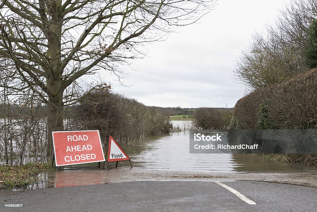 Flooded road Flooded road with warning signs Flood Stock Photo