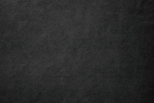 istock black paper texture background. gloomy page for text 1458508540