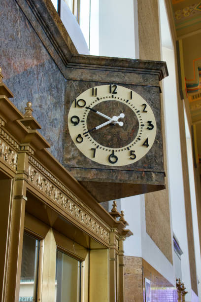 istock Antique ornate clock is visible above the elevator doors 1458508847