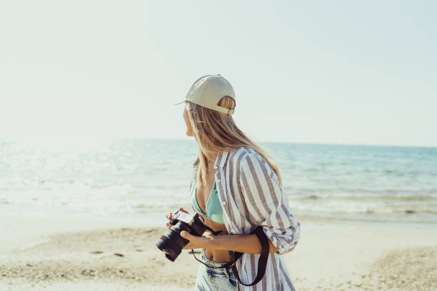 istock Female photographer on the beach 1458509153
