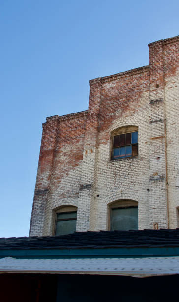 istock Old downtown brick building with deep inset windows 1458510508