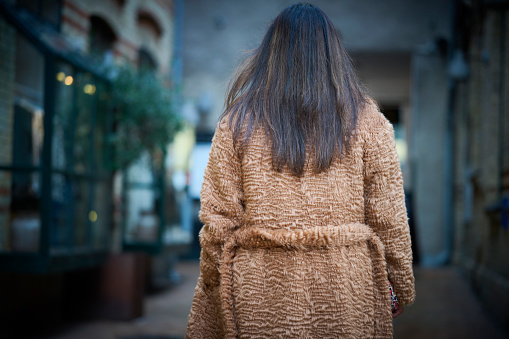 Portrait of Tamil ethnic woman. Rear view of woman in fake fur.