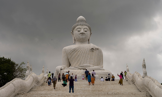 Phuket, Thailand. November 30, 2022. Entrance stairs to the Big Buddha Temple on Phuket island. Visitors taking a tour of the temple. Important travel destinations in Thailand trip.