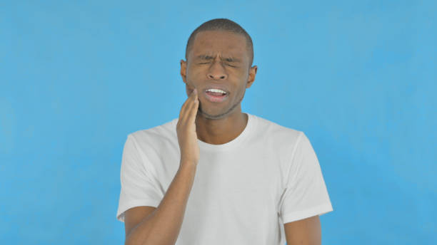 istock African Man with Toothache on Blue Background 1458517645
