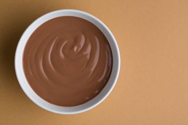 Swirl in a cup of hot chocolate top view isolated on white