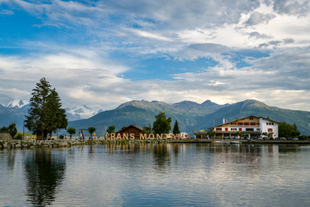 People enjoying their summer vacation around lake in Crans Montant in Switzerland Crans-Montana, Switzerland - August 10, 2020: People enjoying their summer vacation around lake in Crans Montant in Switzerland during summer 2020 crans montana stock pictures, royalty-free photos & images