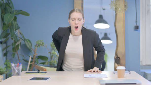 istock Businesswoman with Spinal Back Pain in Office 1458519122