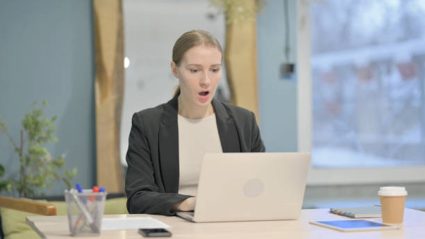 istock Businesswoman Reacting to Loss While Working in Office 1458519436