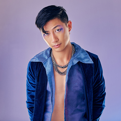 Cyberpunk, makeup and Asian man with fashion for rock, metal identity and futuristic clothes. Freedom, cosmetics and portrait of a young creative rock model with luxury clothing and funky, cool style