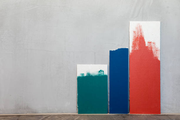 Green blue and red color samplers at blank gypsum plaster wall. Choosing wall paint color during house renovation