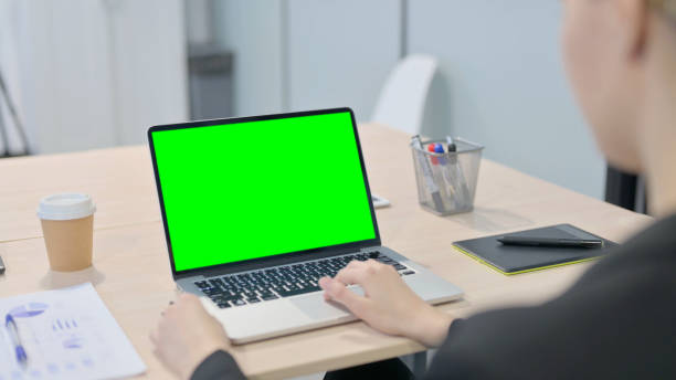 istock Businesswoman Using Laptop with Green Screen 1458520144