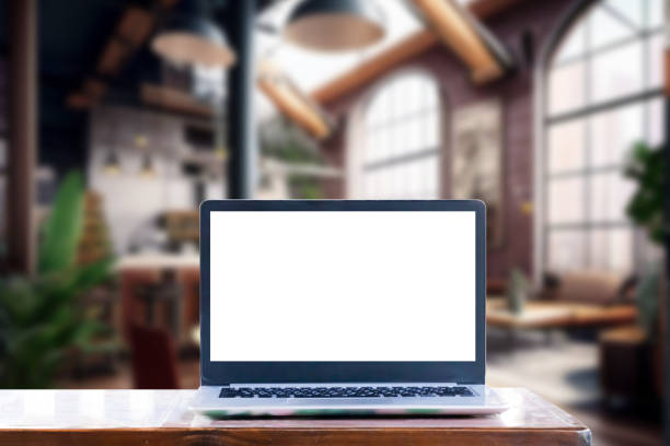 istock Laptop computer on wood desk at office or co-working space, Laptop with white blank on screen and blurred background , working space concept. 1458521084