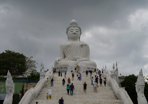 Phuket, Thailand. November 30, 2022. Entrance stairs to the Big Buddha Temple on Phuket island. Visitors taking a tour of the temple. Important travel destinations in Thailand trip.