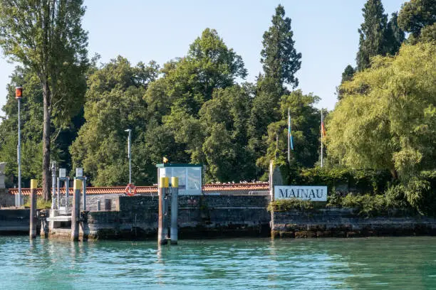 sign at the port of flower island mainau (name of island) in germany , shot taken at the harbour from a boat