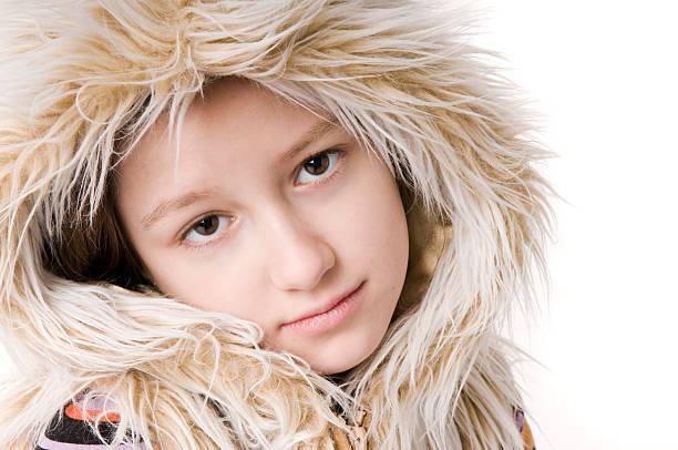 Young girl in a furry hood stock photo