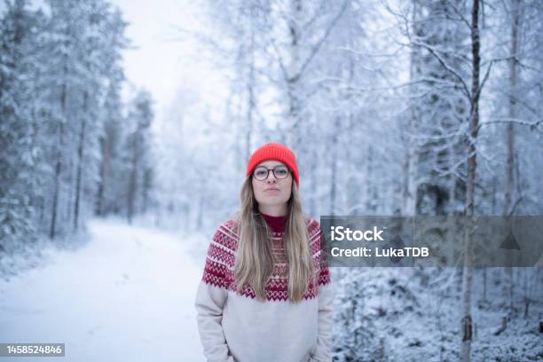 Portrait Of A Woman Walking On A Winter Day Surrounded By A Pine Forest Stock Photo - Download Image Now