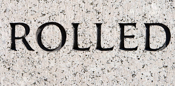 istock Word "Rolled" Carved in Gray Granite 145852854