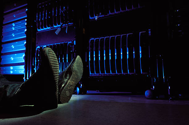 Person lying on the floor in data center stock photo