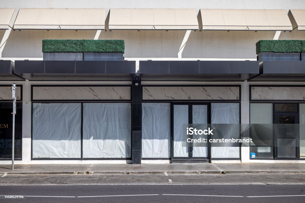 Façade of a empty shop Cape Town, South Africa - December 9th 2022:  Façade of a empty shop with blinded windows Store Stock Photo