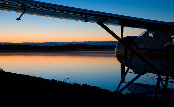 Seaplane by Side of Lake at Sunset stock photo