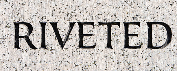 istock Word "Riveted" Carved in Gray Granite 145853029
