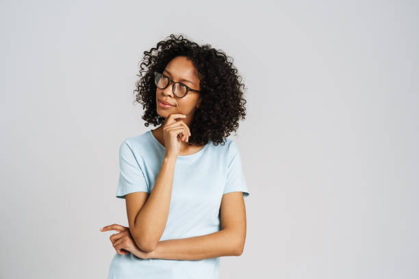 istock Black puzzled woman wearing eyeglasses posing and looking aside 1458532097
