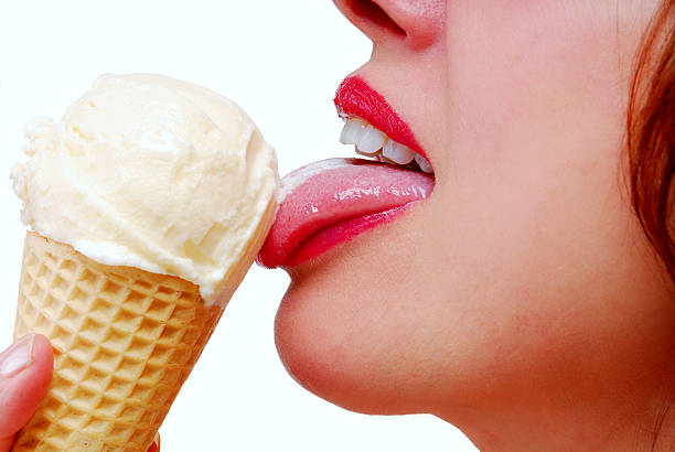 Female Lips with Ice Cream Cone Close-up female lips with red lipstick eating a vanilla ice cream cone licking ice cream cone stock pictures, royalty-free photos & images