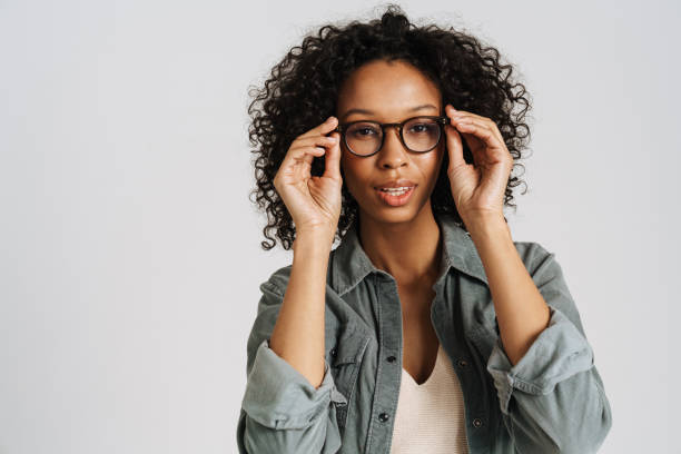 istock Black curly woman wearing eyeglasses posing and looking at camera 1458534890