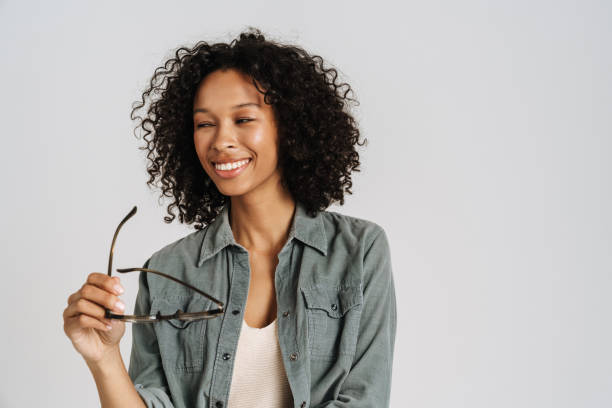istock Black curly woman with eyeglasses smiling and looking aside 1458534919