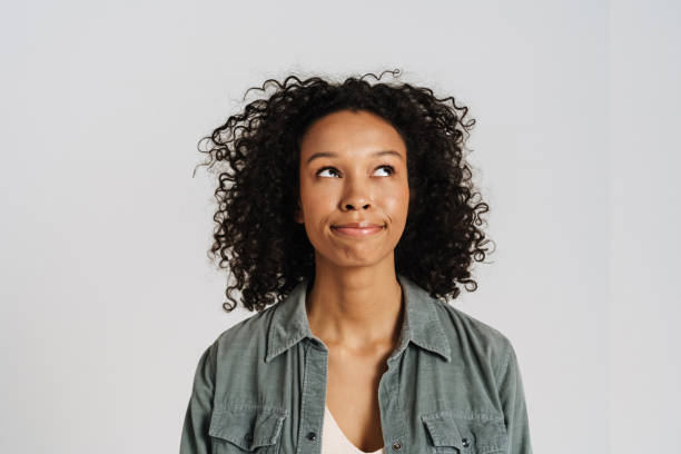 istock Black young woman grimacing while looking upward 1458536029