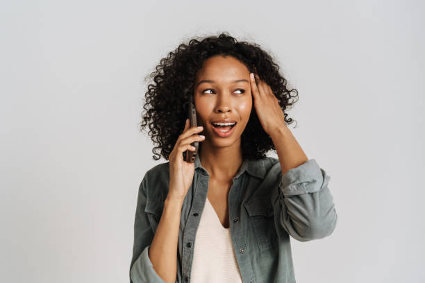 istock Black young woman smiling and talking on cellphone 1458536574