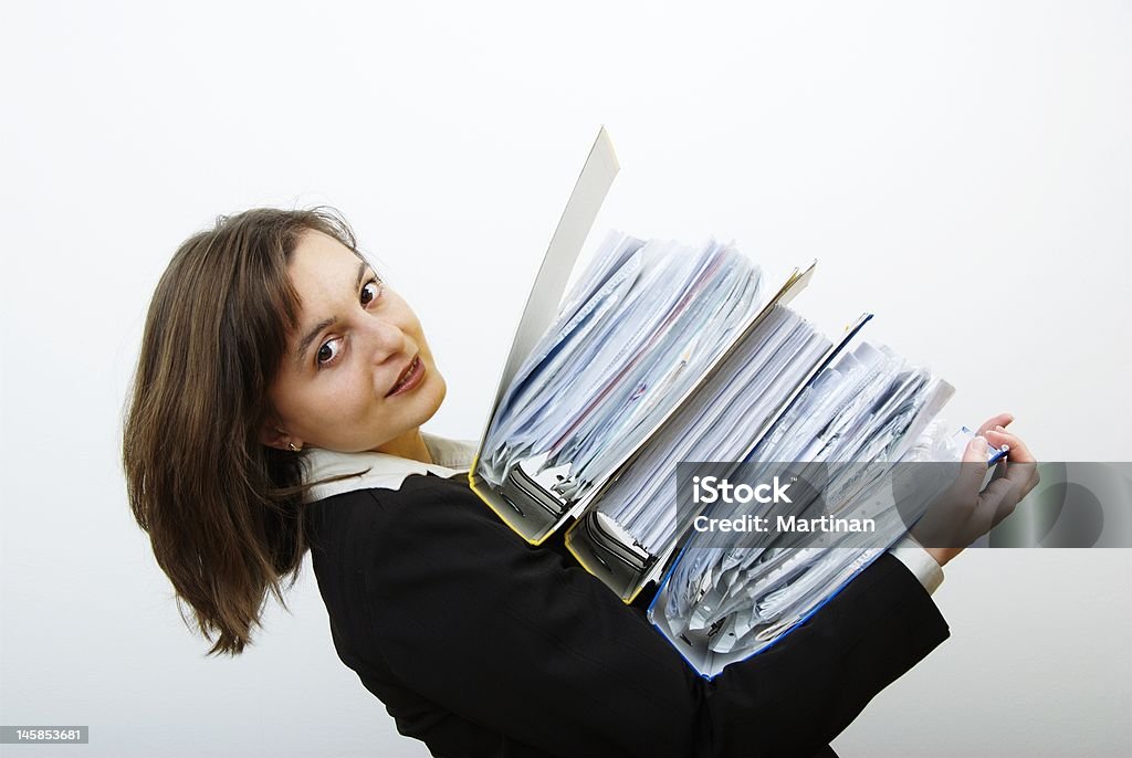 Business woman overloaded with heavy files Woman dressedin suit wearing heavy files Assistance Stock Photo