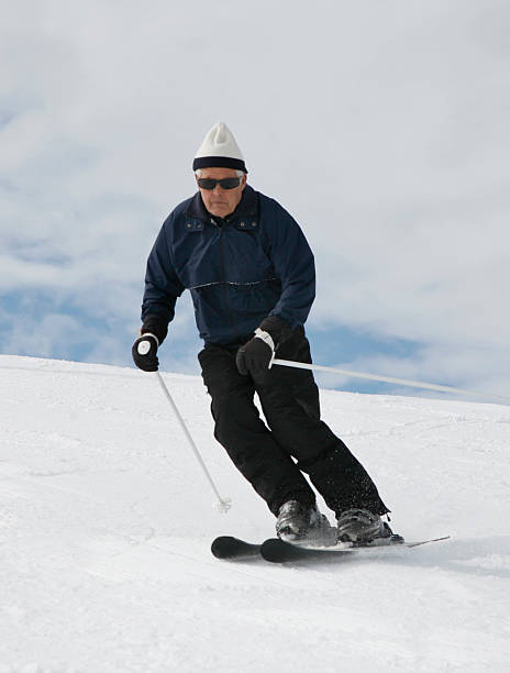 Grandfather Enjoying Alpine Skiing stock photo