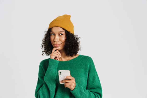 istock Black puzzled woman wearing hat using mobile phone 1458540504